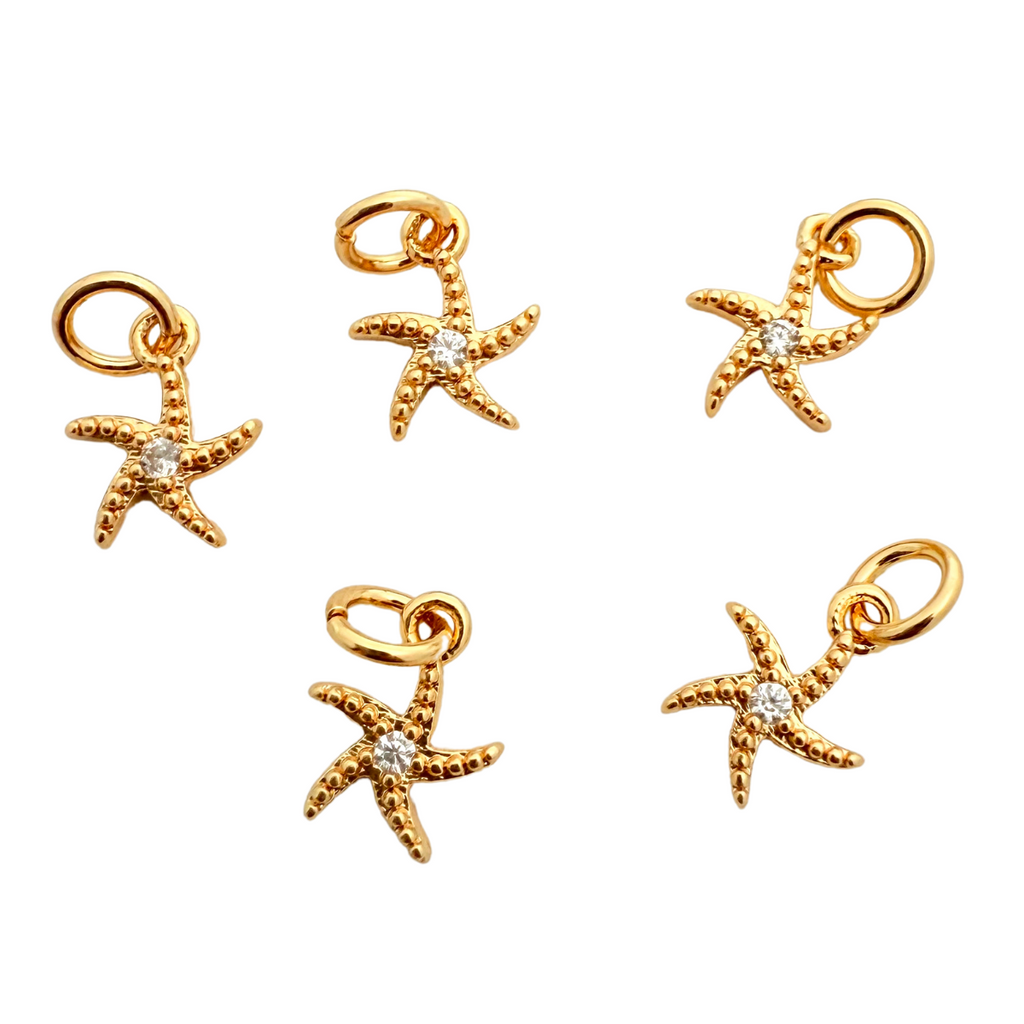 A set of five gold-plated tarnish-resistant CZ starfish charms, each featuring a small clear cubic zirconia in the center.